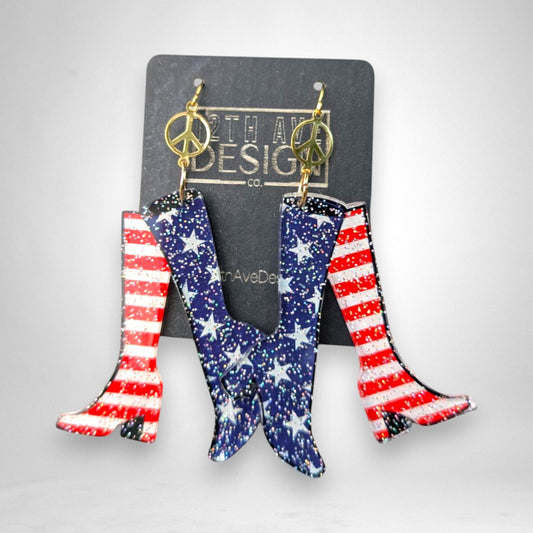 12th Ave Design Co. patriotic go-go boot earrings with US flag print, gold peace sign charms, and mini-hooks.