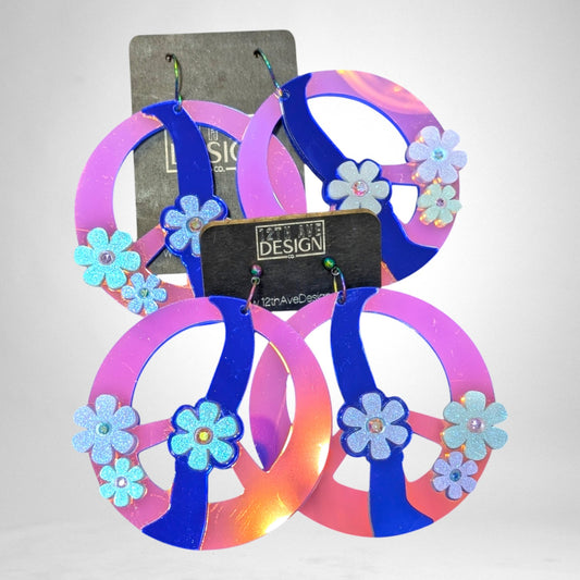 12th Ave Design Co. custom peace sign earrings featuring pink and blue iridescent acrylic with glitter flower accents