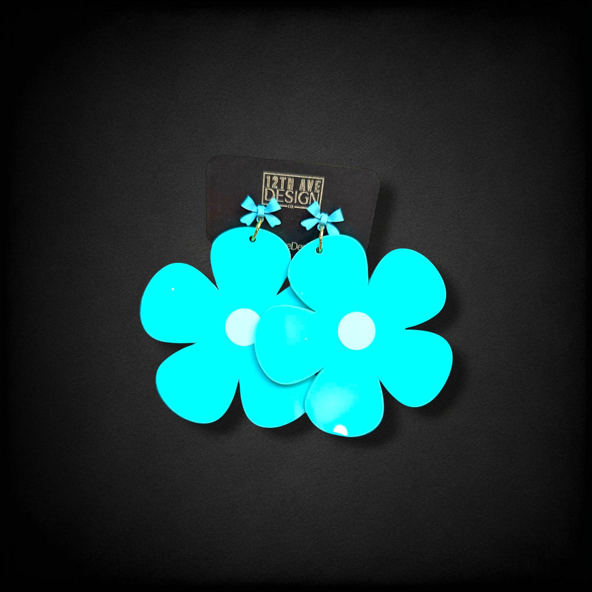 12th Ave Design Co. bright turquoise bubble daisy earrings with small bow accents and modern gold-plated hooks.
