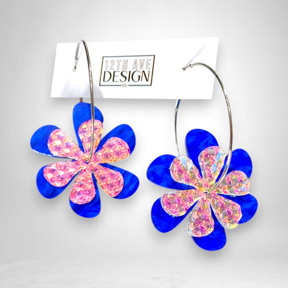 12th Ave Design Co. blue and iridescent acrylic daisy flower hoop earrings with silver stainless steel hardware.