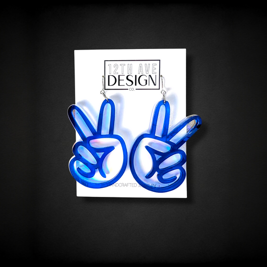 12th Ave Design Co. blue translucent peace sign hand earrings with iridescent shimmer. 2.5" drop.