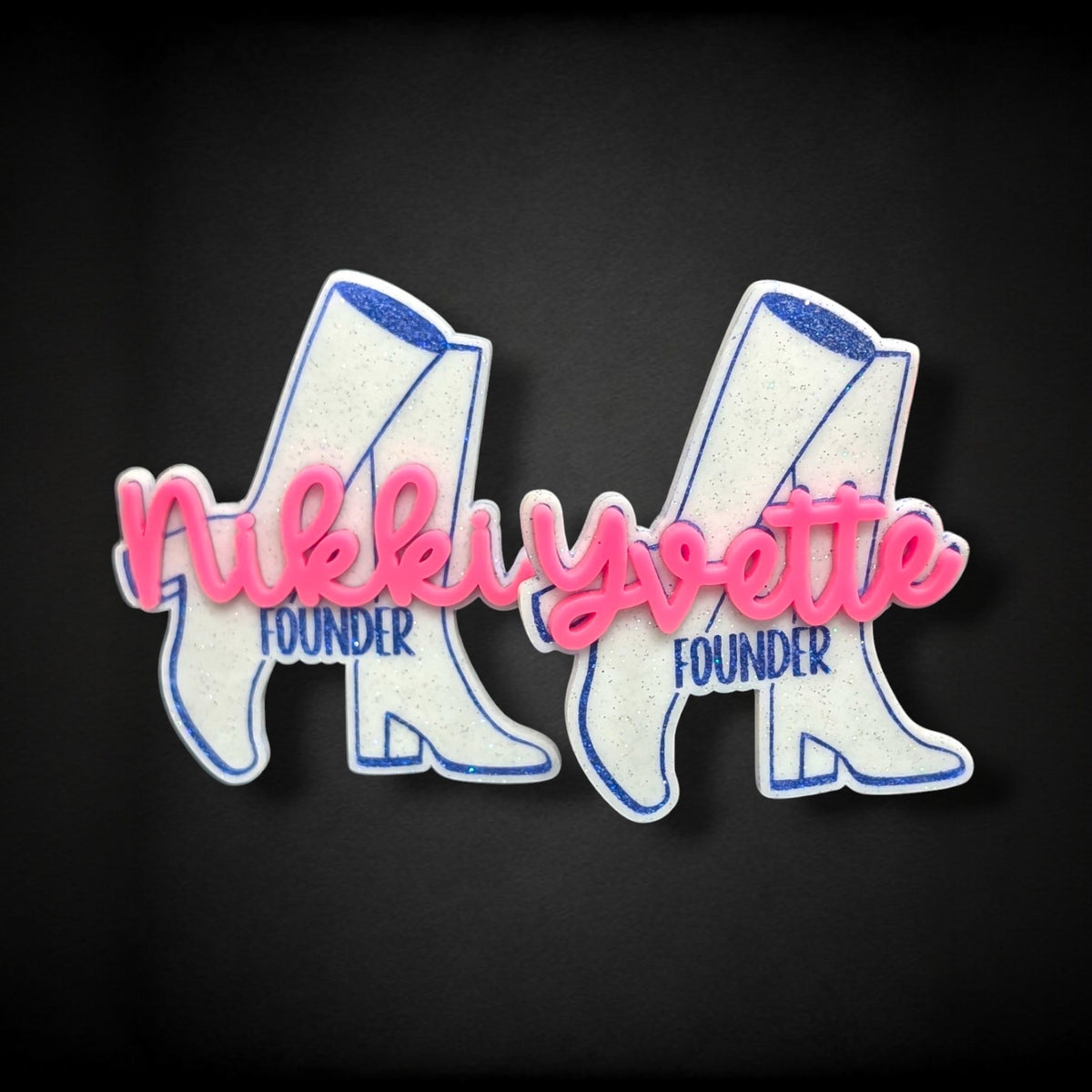 12th Ave Design Co. custom white glitter acrylic boot nametags with pink 3D script names and blue text on black