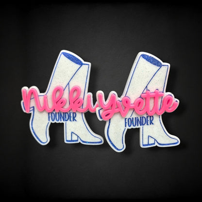 12th Ave Design Co. custom white glitter acrylic boot nametags with pink 3D script names and blue text on black