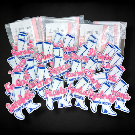 12th Ave Design Co. custom glitter acrylic boot-shaped nametags with personalized names and titles for a group.