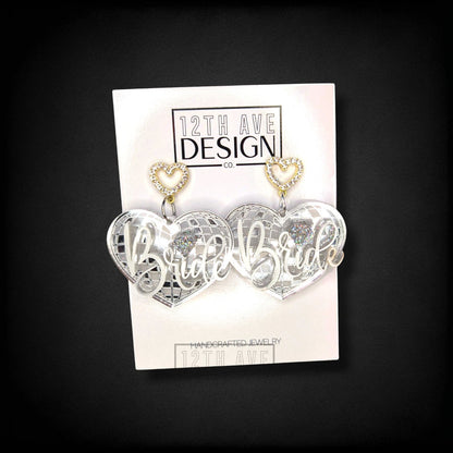 12th Ave Design Co. custom silver mirror heart earrings with Bride script and rhinestone heart studs