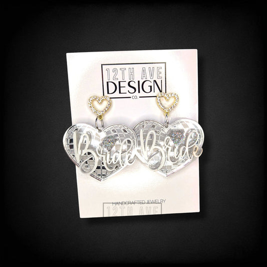 12th Ave Design Co. custom silver mirror heart earrings with Bride script and rhinestone heart studs