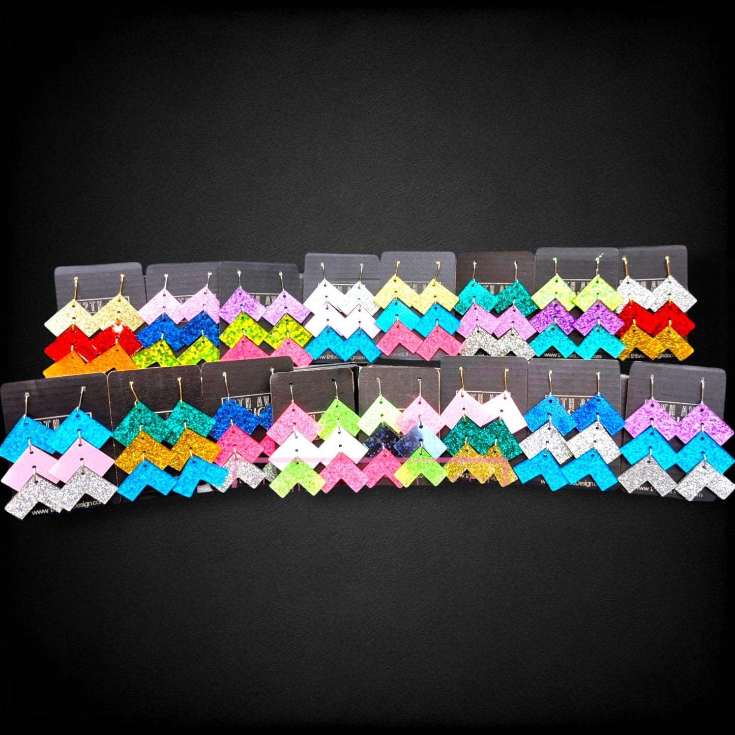 12th Ave Design Co. custom chevron glitter earrings in various vibrant colors displayed on black backing cards.