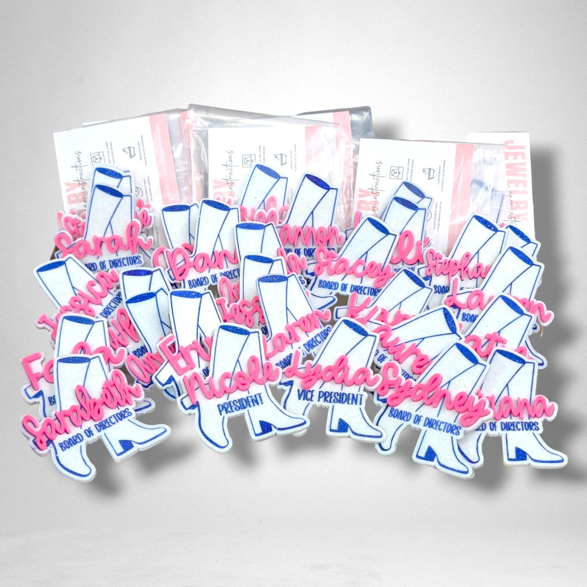 12th Ave Design Co. custom glittery white and blue cowboy boot nametags with pink script names for a group event.