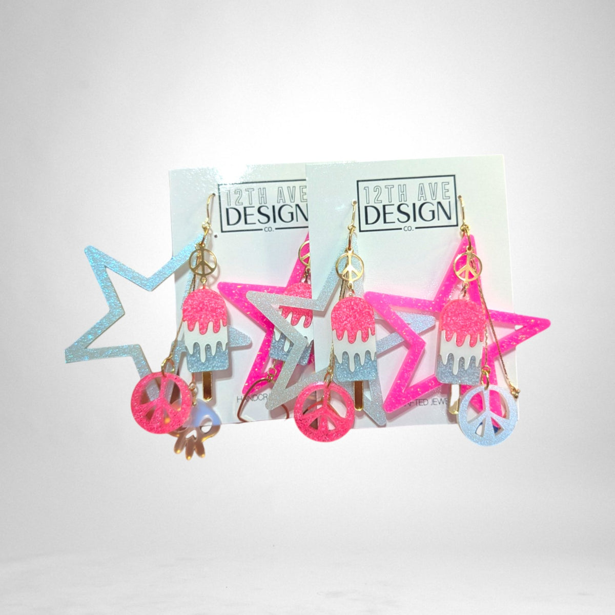 12th Ave Design Co. custom glittery star and popsicle earrings with peace sign charms in pink and blue