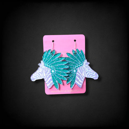 12th Ave Design Co. custom glittery teal and white zebra head earrings with headdress detail on a pink display card