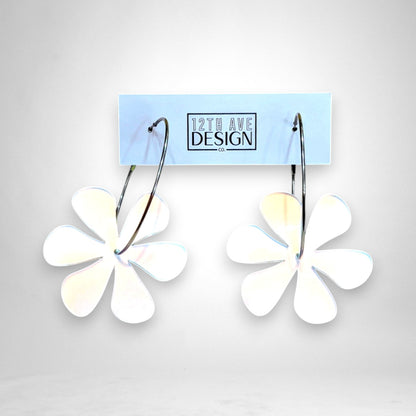 12th Ave Design Co. floating daisy hoop earrings featuring white acrylic flower charms on silver stainless steel hoops