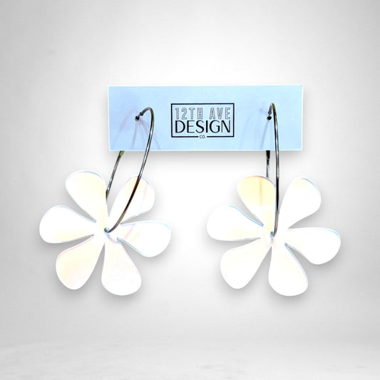 12th Ave Design Co. floating daisy hoop earrings featuring white acrylic flower charms on silver stainless steel hoops