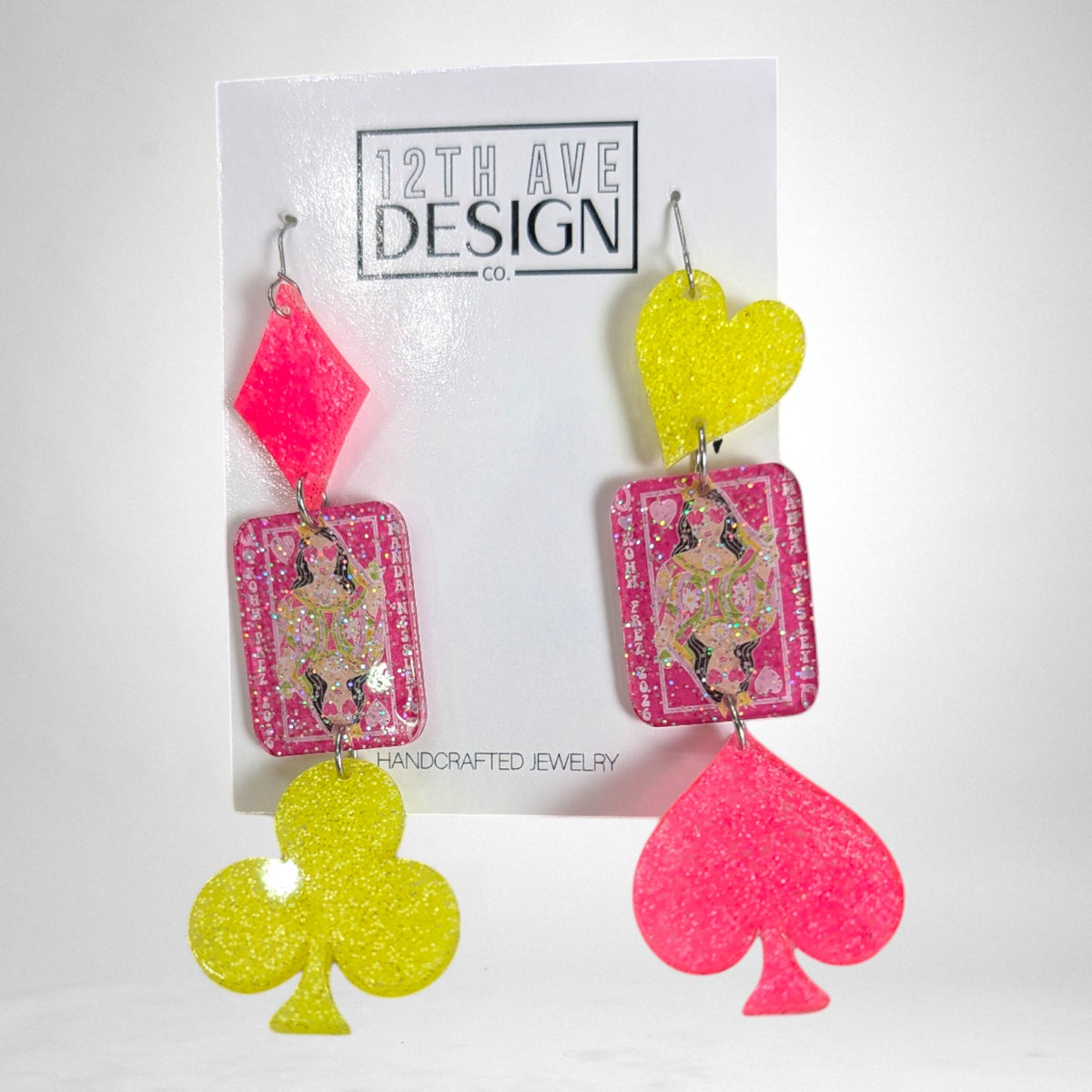 12th Ave Design Co. custom glitter resin playing card earrings with neon pink and yellow suit shapes.