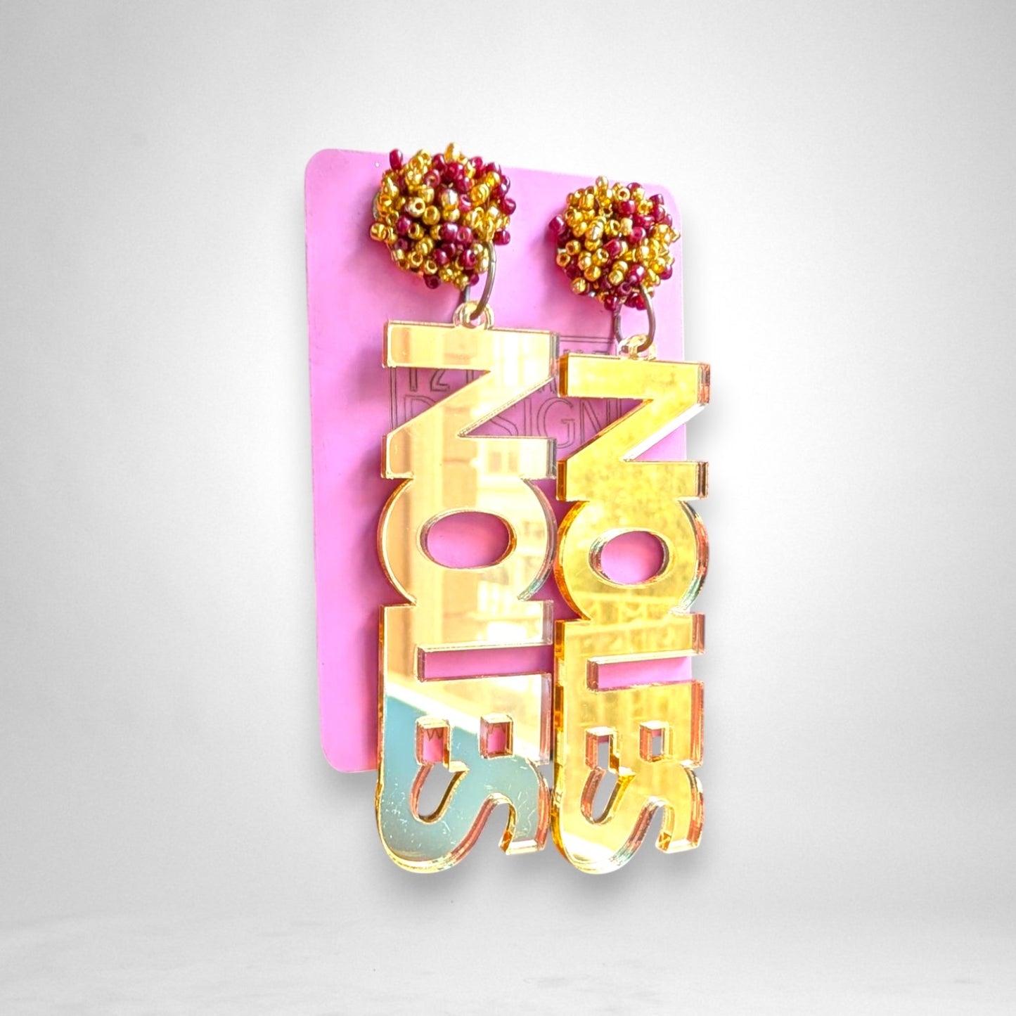 12th Ave Design Co. gold mirror acrylic Noles block text earrings with maroon and gold seed bead pom accents.