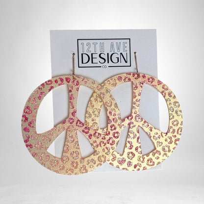 12th Ave Design Co. custom peace sign earrings featuring a gold and pink glitter leopard print pattern