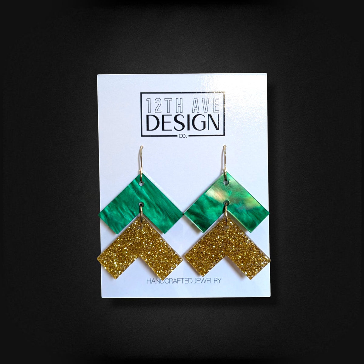 12th Ave Design Co. green and gold glitter chevron drop earrings with surgical steel hooks on display card