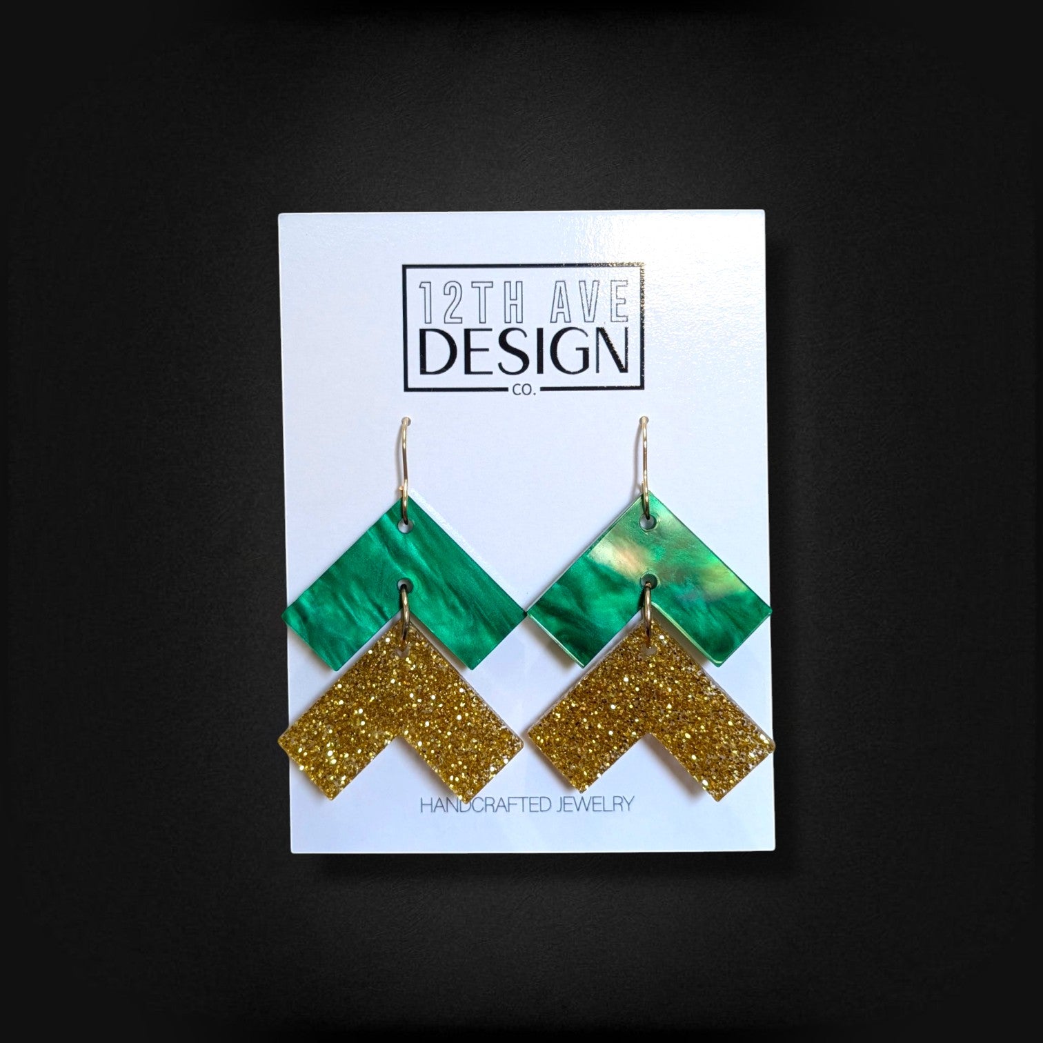 12th Ave Design Co. green and gold glitter chevron drop earrings with surgical steel hooks on display card