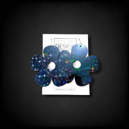 12th Ave Design Co. Bubble Daisy earrings featuring a dark holographic star pattern on large five-petal flowers.