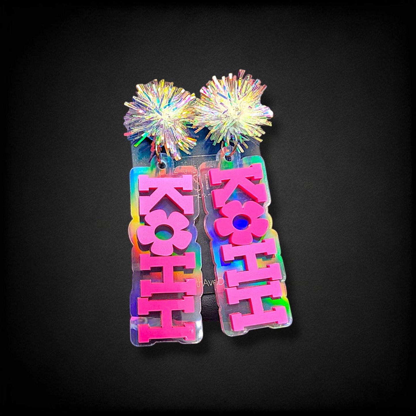 12th Ave Design Co. KOHH Varsity Bloom earrings featuring iridescent acrylic bases and pink engraved lettering.
