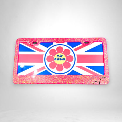 12th Ave Design Co. KOHH aluminum car tag featuring a Union Jack background, pink glitter frame, and flower logo.