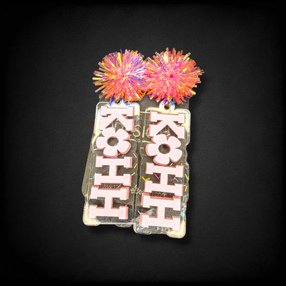 12th Ave Design Co. KOHH Varsity Bloom earrings featuring iridescent acrylic bases with pink lettering and pom-poms.