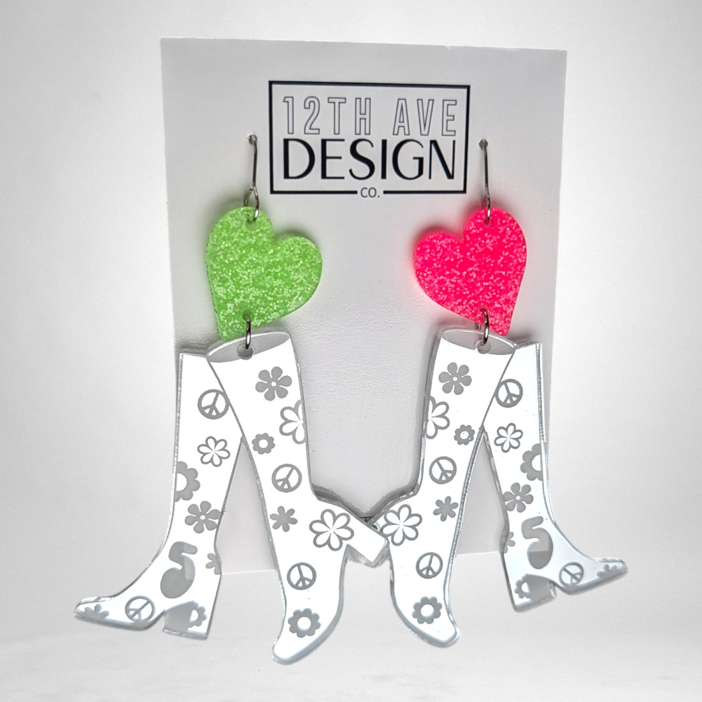 12th Ave Design Co. custom earrings featuring mirrored silver go-go boots with floral and peace sign accents