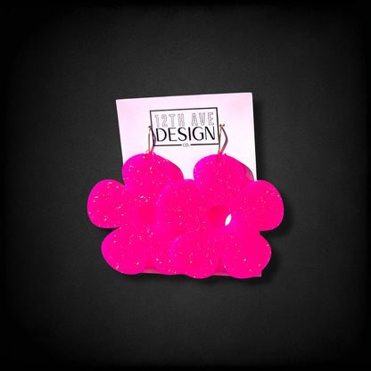 12th Ave Design Co. neon pink glitter bubble daisy earrings with gold hooks on a branded display card.