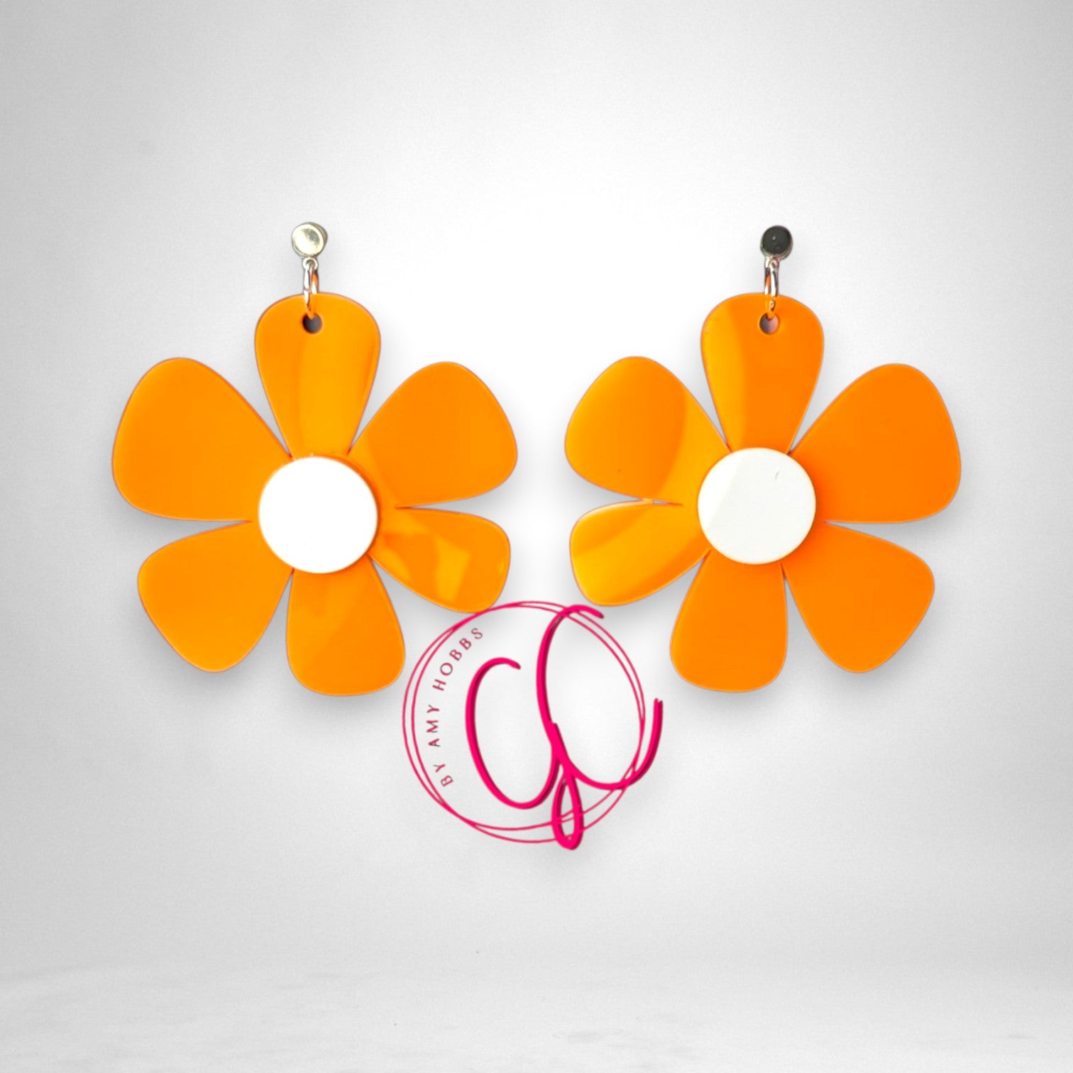 12th Ave Design Co. groovy orange and white flower statement earrings with a bold retro design
