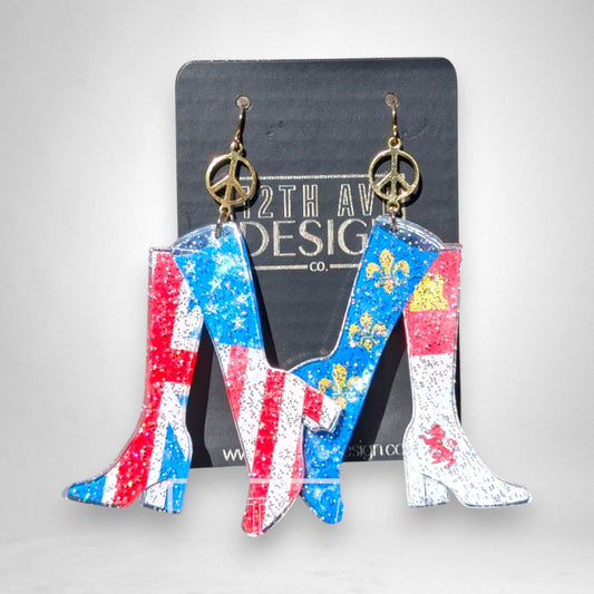 12th Ave Design Co. patriotic go-go boot earrings with flag prints, gold peace sign charms, and gold-plated hooks.