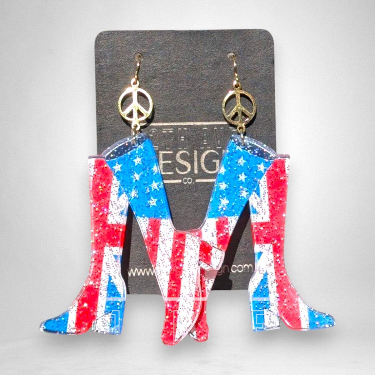 12th Ave Design Co. Hype Girl go-go boot earrings featuring US and UK flag prints with gold peace sign charms.