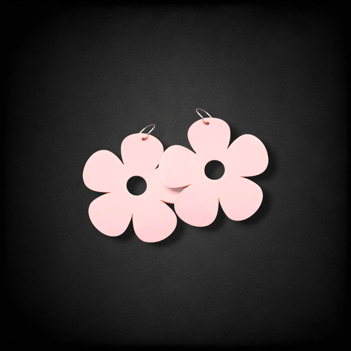 12th Ave Design Co. light pink bubble daisy earrings with five petals and a central cutout on modern metal hooks.