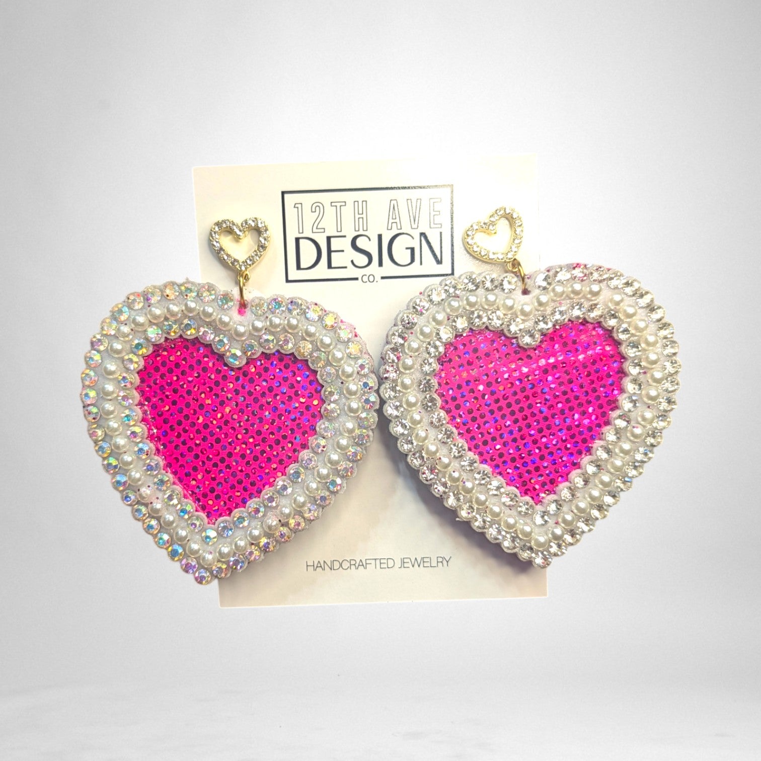 12th Ave Design Co. custom heart-shaped earrings featuring hot pink sequins, white pearls, and rhinestone trim.