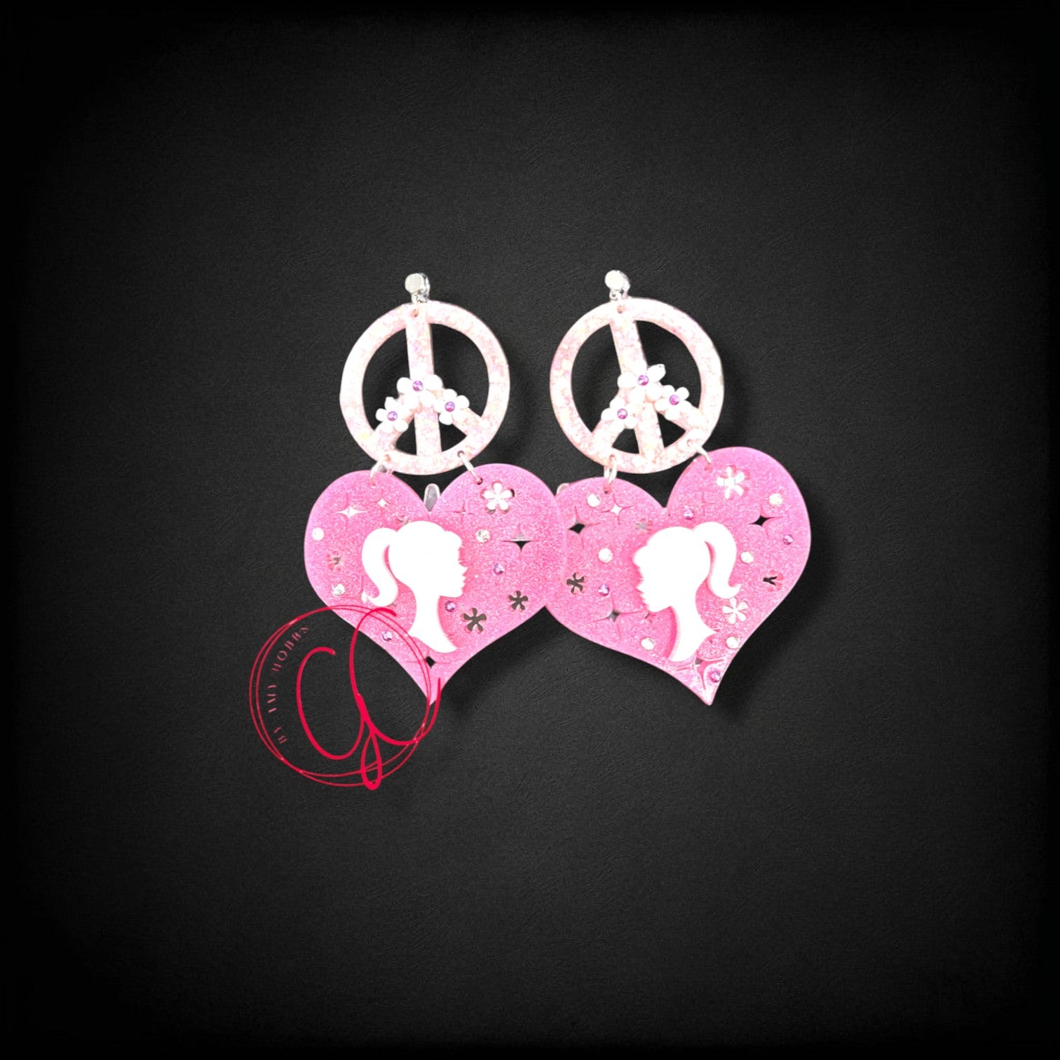 12th Ave Design Co. custom pink glitter heart earrings featuring peace signs and silhouette profiles