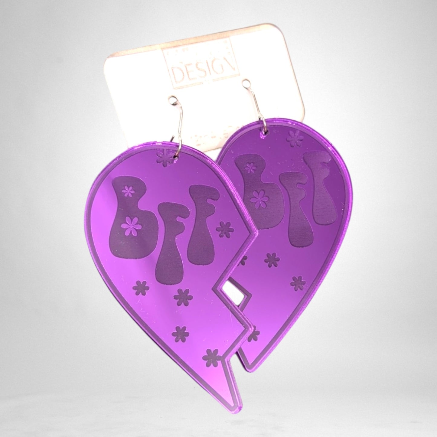 12th Ave Design Co. purple acrylic BFF heart earrings with groovy flower cutouts on a branded display card
