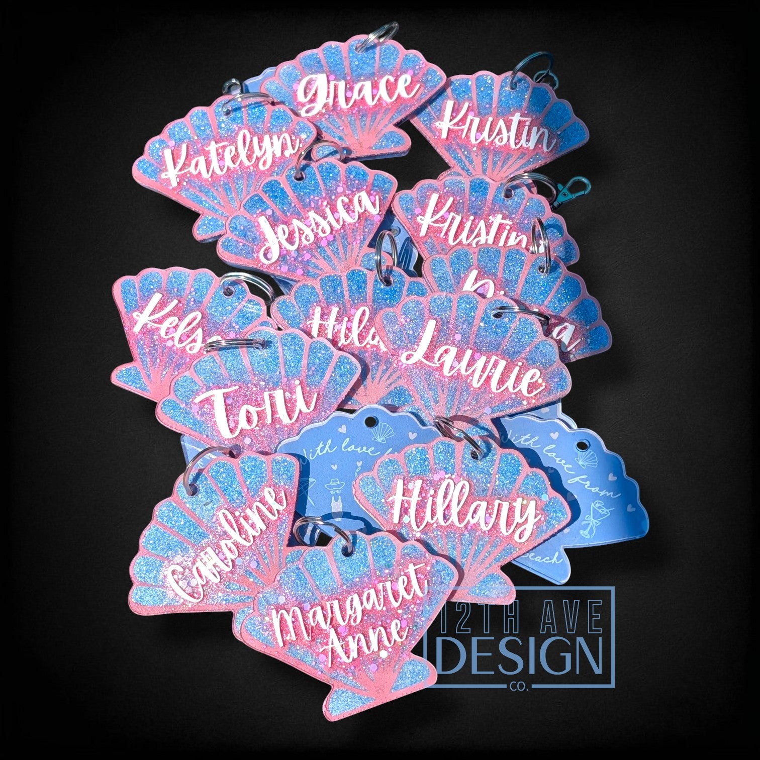 12th Ave Design Co. custom seashell-shaped acrylic keychains with blue glitter and white script names