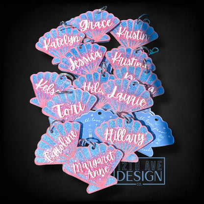12th Ave Design Co. custom seashell-shaped acrylic keychains with blue glitter and white script names