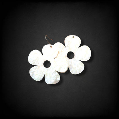 12th Ave Design Co. white iridescent bubble daisy earrings with five petals and modern hooks on a black background.